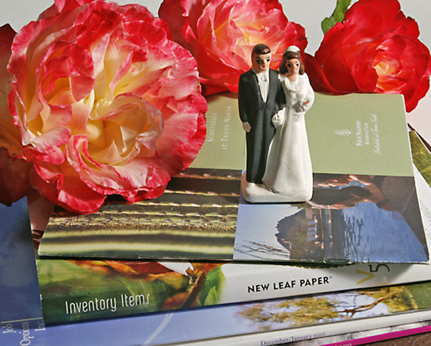 Printed brochures with 3 roses and vintage wedding couple cake topper. 